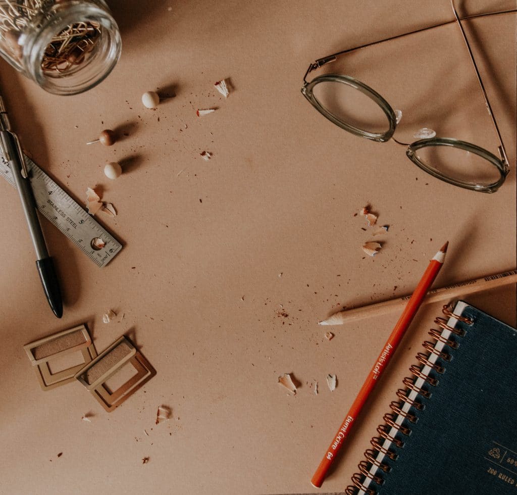 red pencil beside black and silver scissors